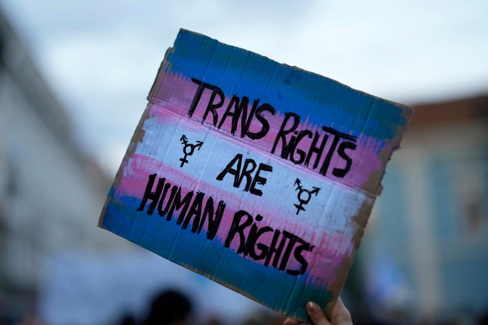 A demonstrator holds up a sign during a march to mark International Transgender Day of Visibility in Lisbon, Portugal, on March 31, 2022.