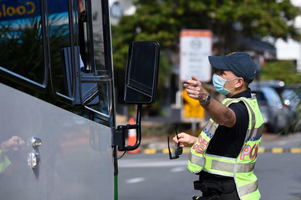 Police are seen directing motorists at the Coolangatta border check point on Griffith St in Gold Coast, Australia. 