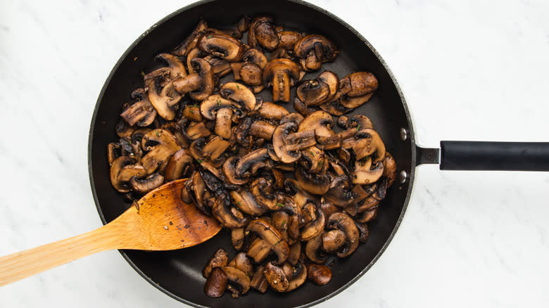 Mushrooms frying in pan