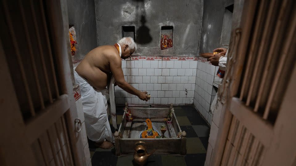 Vishwambhar Nath Mishra prays inside his temple in Varanasi. - John Mees/CNN