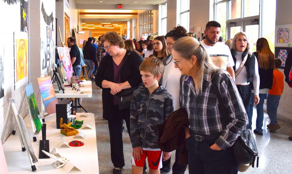 Millersburg third-grader Ben Kaster and his grandmother, Pam Kaster, were among the many visitors to West Holmes High School on Friday to admire the artistic talents of students throughout the district at the Fine Arts Festival.