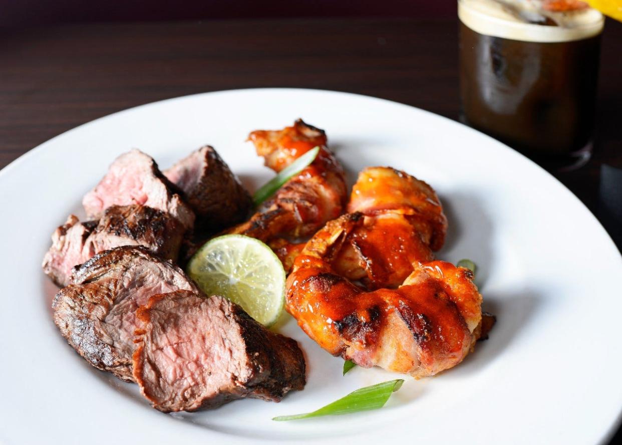 On the menu at the new Lewis Prime Grill in Loxahatchee: sliced beef tenderloin served with bacon-wrapped shrimp in a bourbon chipotle glaze.