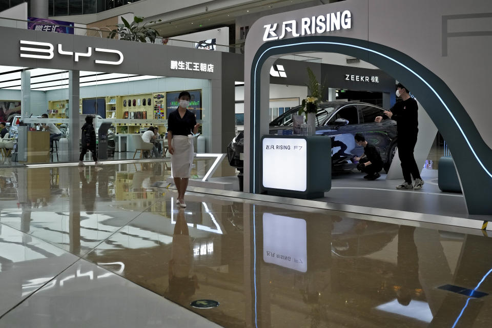 A Rising F7 car model is on display at a floor section selling various Chinese-made electric car brands inside a shopping mall in Beijing, Tuesday, April 4, 2023. Furious at U.S. efforts that cut off access to technology to make advanced computer chips, China's leaders appear to be struggling to figure out how to retaliate without hurting their own ambitions in telecoms, artificial intelligence and other industries. (AP Photo/Andy Wong)