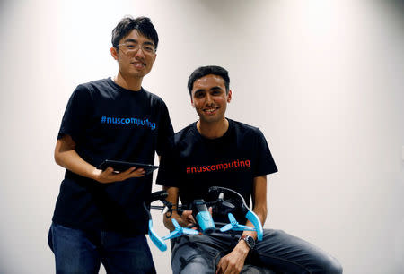 NUS School of Computing researchers Lan Ziquan and Mohit Shridhar showcase their project Xpose, an interactive drone photo-taking system, at their faculty premises in Singapore November 27, 2017. REUTERS/Edgar Su/Files