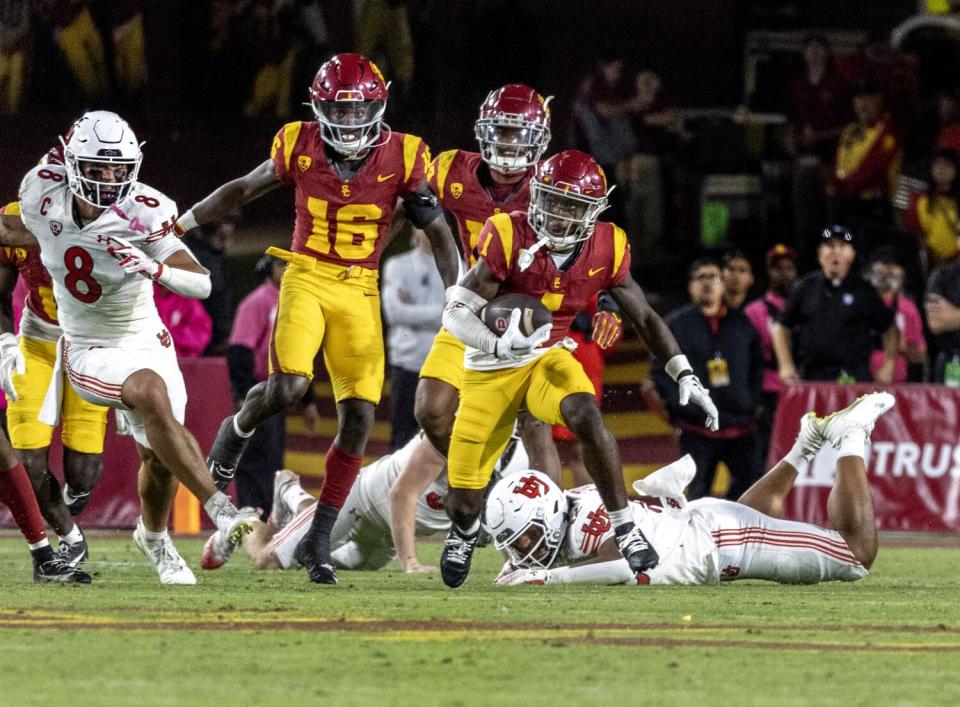 USC receiver Zachariah Branch breaks tackles for a long comeback against Utah at the Coliseum on Oct. 21.