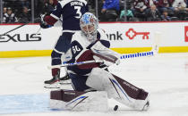 Colorado Avalanche goaltender Justus Annunen, foreground, makes pad-save of a shot in the second period of an NHL hockey game against the Winnipeg Jets, Saturday, April 13, 2024, in Denver. (AP Photo/David Zalubowski)