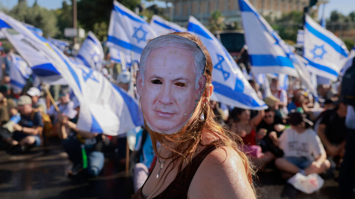 A demonstrator wearing a Netanyahu mask takes part in a sit-in to block the entrance of the Knesset, the Israel Parliament, in Jerusalem
