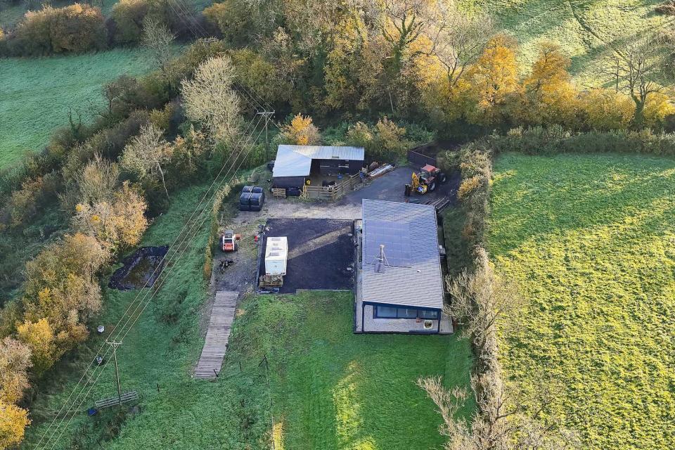 BNPS.co.uk (01202 558833)
Pic: Graham Hunt/BNPS

EMBARGO - IMAGES NOT TO BE USED ONLINE BEFORE 9AM TUESDAY (05/12/23) - EMBARGO

Pictured: Aerial view of a house on Winters Hill Lane at West Compton near Shepton Mallet in Somerset which was build without planning permission.

A well-respected businessman is facing the daunting prospect of demolishing his new home after illegally building it during lockdown.

Tony Harvey failed to obtain planning permission when he self-built the contemporary family home near Glastonbury, Somerset.

The controversial property - worth about Â£400,000 - sits on agricultural land once owned by his late grandfather in the village of West Compton.