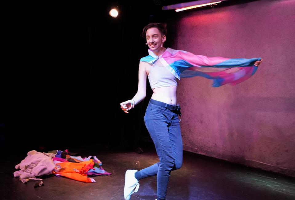 Draped in the transgender pride flag, drag entertainer Alexander Blu Midos delivers an emotional performance during a youth drag show at The Garden in the East Village in Des Moines on Sunday, Sept. 18, 2022.