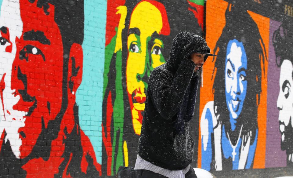 A pedestrian walks through a winter nor'easter snow storm in Lawrence