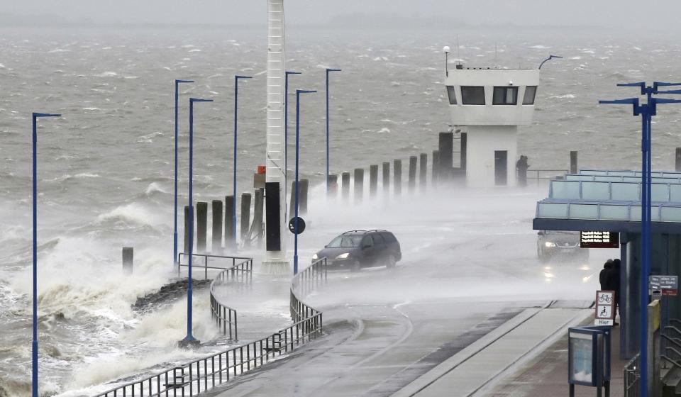 Water splashes on the pier of the ferry pier in Dagebuell, northern Germany, Sunday, Feb. 9, 2020. Weather warnings issued across northern Europe as the storm with winds expected to reach hurricane levels batters the region. (Bodo Marks/dpa via AP)