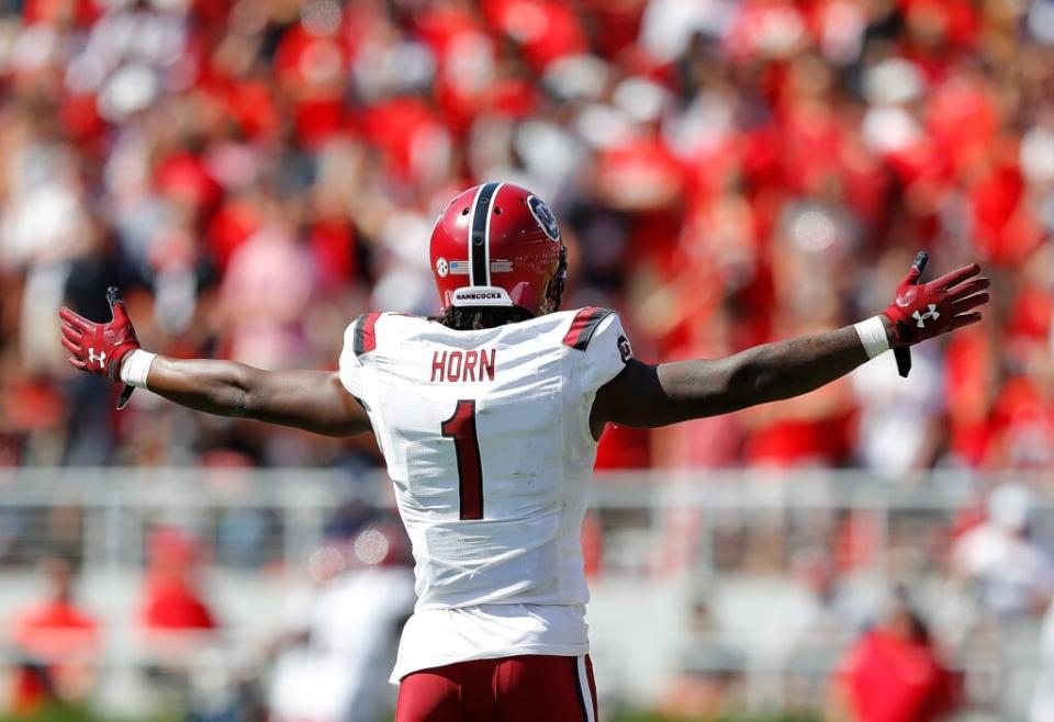 Jaycee Horn #1 of the South Carolina Gamecocks reacts as Israel Mukuamu #24 returns an interception for a touchdown in the first half against the Georgia Bulldogs at Sanford Stadium on October 12, 2019 in Athens, Georgia. (Photo by Kevin C. Cox/Getty Images)