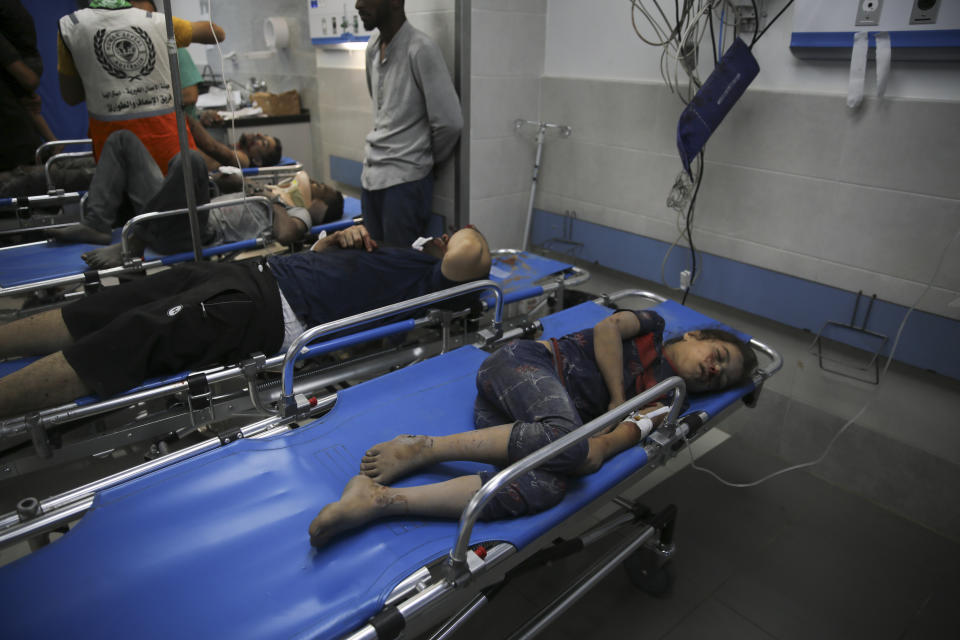 Palestinians wounded in Israeli strikes wait for treatment in Shifa Hospital in Gaza City, Friday, Oct. 13, 2023. (AP Photo/Ali Mahmoud)