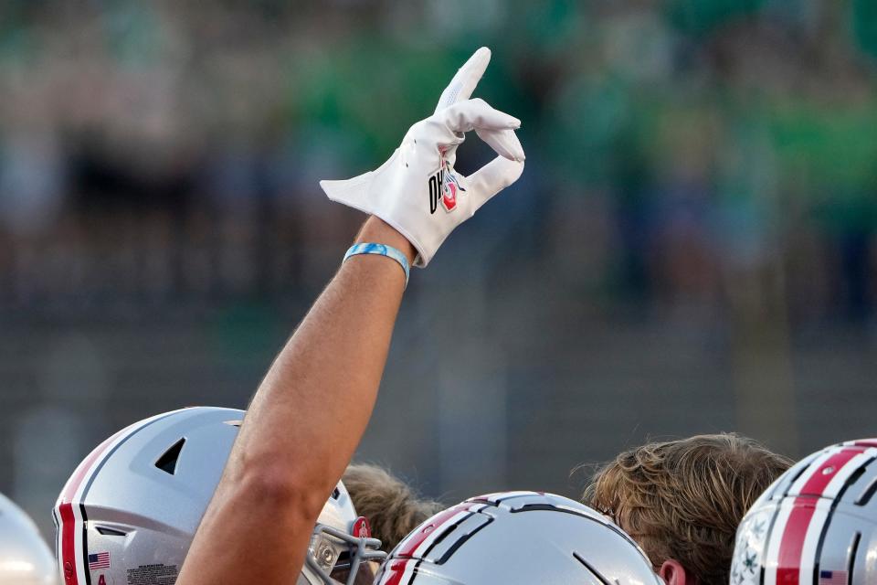 Sep 23, 2023; South Bend, Indiana, USA; Ohio State Buckeyes wide receiver Julian Fleming (4) holds up one finger during warm-ups before the game against Notre Dame Fighting Irish at Notre Dame Stadium.