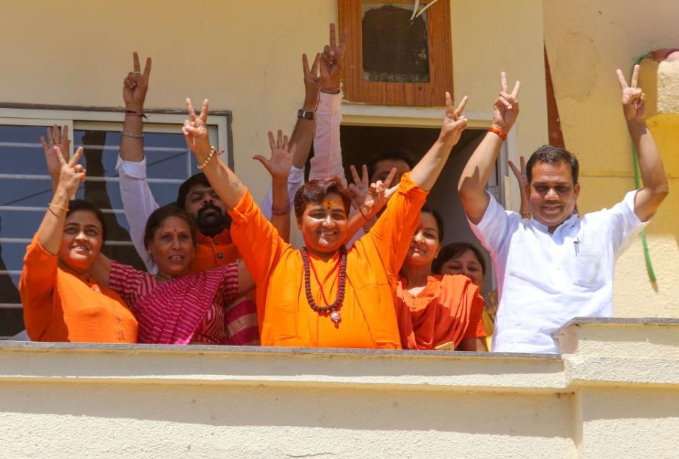 Indian Bharatiya Janata Party (BJP) candidate Pragya Singh Thakur, known as Sadhvi Pragya, gestures along with other BPJ supporters on the vote results day for India's general election at her residence in Bhopal on May 23, 2019. | Gagan Nayar—AFP/Getty Images