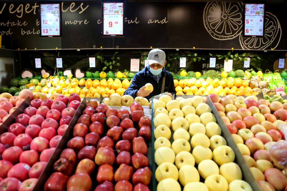 A man picking out products in a grocery store