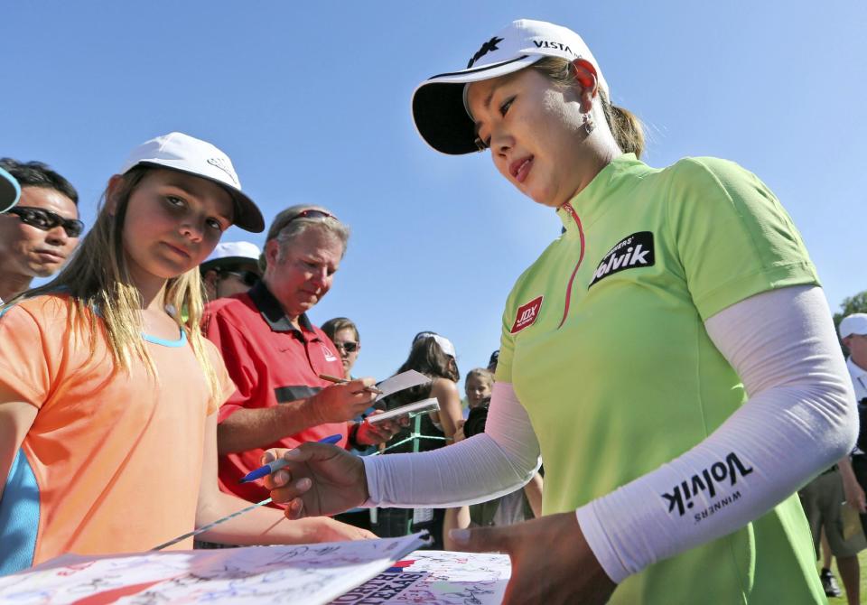 Meena Lee, of South Korea, signs autographs after her third round in the North Texas LPGA Shootout golf tournament at the Las Colinas Country Club in Irving, Texas, Saturday, May 3, 2014. (AP Photo/LM Otero)