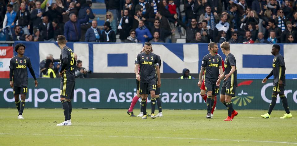 Juventus players react After Spal's Sergio Floccari scored during the Serie A soccer match between Spal and Juventus, at the Paolo Mazza stadium in Ferrara, Italy, Saturday, April 13, 2019. (AP Photo/Antonio Calanni)