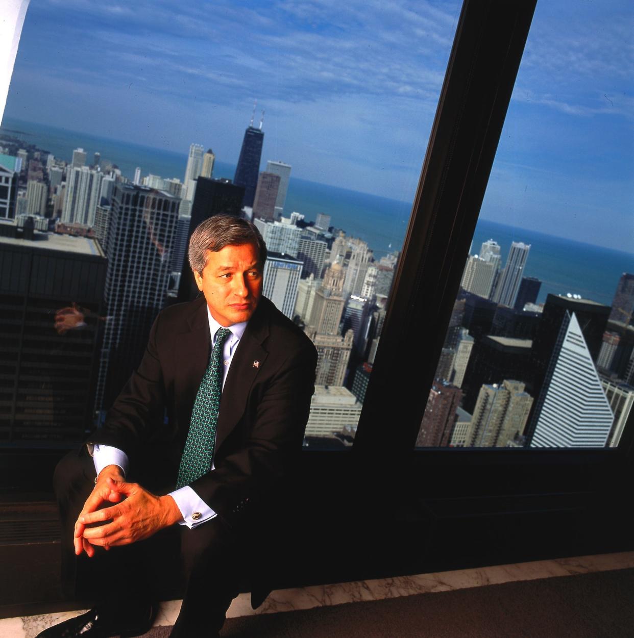 Jamie Dimon poses in front of a picture window in his office,