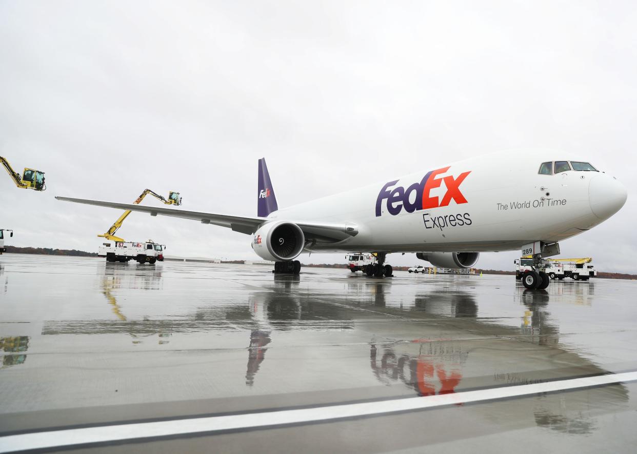 A Fedex plane is parked next to a deicing truck on Nov. 29, 2022 at Memphis International Airport in Memphis.