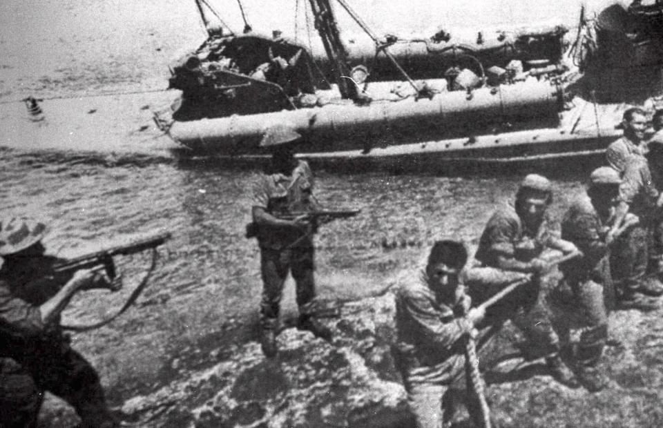 FILE- In this file photo dated July 20 1974, Turkish troops pull ashore a Greek Cypriot torpedo boat damaged during fighting in Kyrenia on the day Turkey invaded and occupied the northern third of Cyprus. Europe's top human rights court on Monday May 12, 2014, ordered Turkey to pay 90 million euros ($123 million) to Cyprus over the 1974 invasion of the island and its subsequent division, in one of the largest judgments in its history, saying that the passage of time did not erase responsibility in the case. The judgment comes as the Turkish and Greek Cypriot communities are engaged in renewed efforts to reunite the island.(AP Photo, FILE)