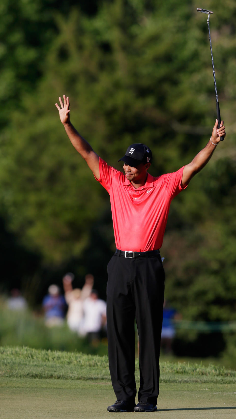 Tiger Woods celebrates on the 18th hole after winning the AT&T National at Congressional Country Club on July 1, 2012 in Bethesda, Maryland. (Photo by Rob Carr/Getty Images)