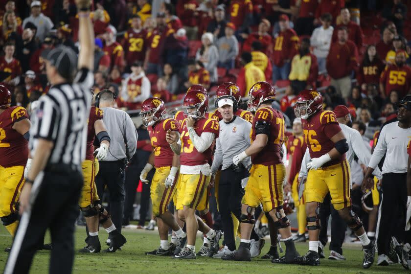 USC coach Lincoln Riley talks with his players on the sideline during the fourth quarter of a game against Notre Dame