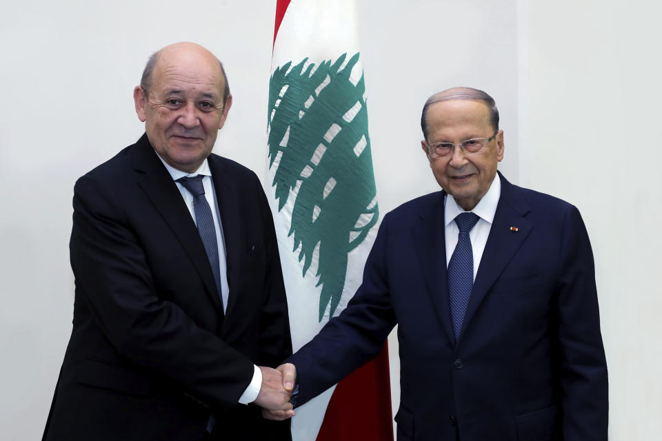 In this photo released by Lebanon's government, Lebanese president Michel Aoun, left, shakes hands with French Foreign Minister Jean-Yves Le Drian, at the Presidential Palace, in Baabda, east of Beirut, Lebanon, Thursday, July 23, 2020. Le Drian is in Lebanon for two days visit to meet with Lebanese officials and top politician leaders. (Dalati Nohra/Lebanon's government via AP)