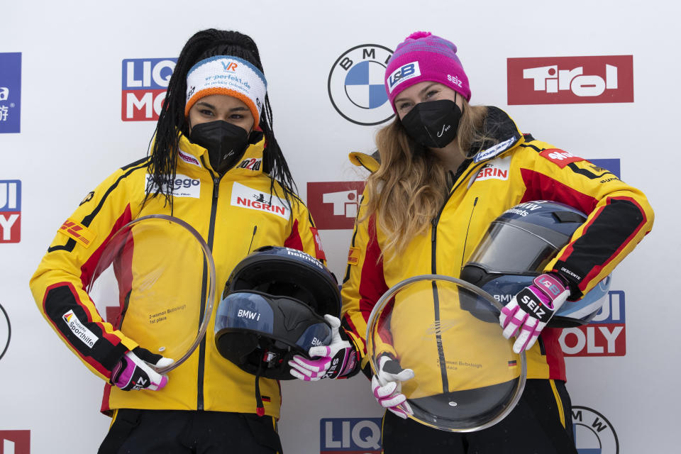 Laura Nolte and Deborah Levi from Germany celebrate after winning the women's two-women bobsleigh World Cup race, in Igls, near Innsbruck, Austria, Sunday, Nov. 28, 2021. (AP Photo/Lisa Leutner)