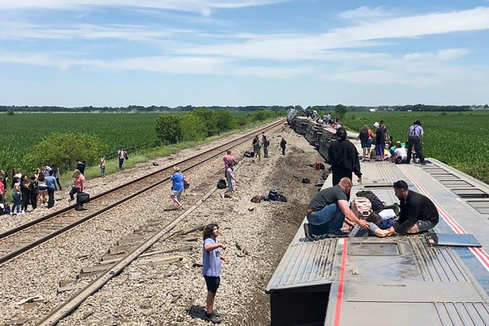 In this photo provided by Dax McDonald, an Amtrak passenger train lies on its side after derailing near Mendon, Missouri, on Monday (AP)