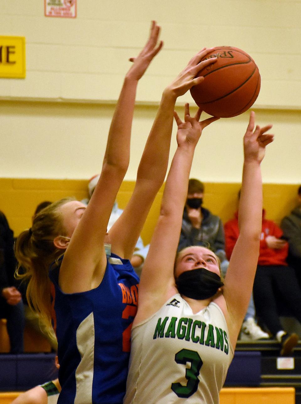 Brookfield Beaver Megan Kupris (left) gets a hand on a shot by Herkimer Magician Aubrey Lewis during Friday's consolation game at Richfield Springs' holiday tournament. Brookfield won the game and both Kupris and Lewis were selected for the tournament's all-star team.