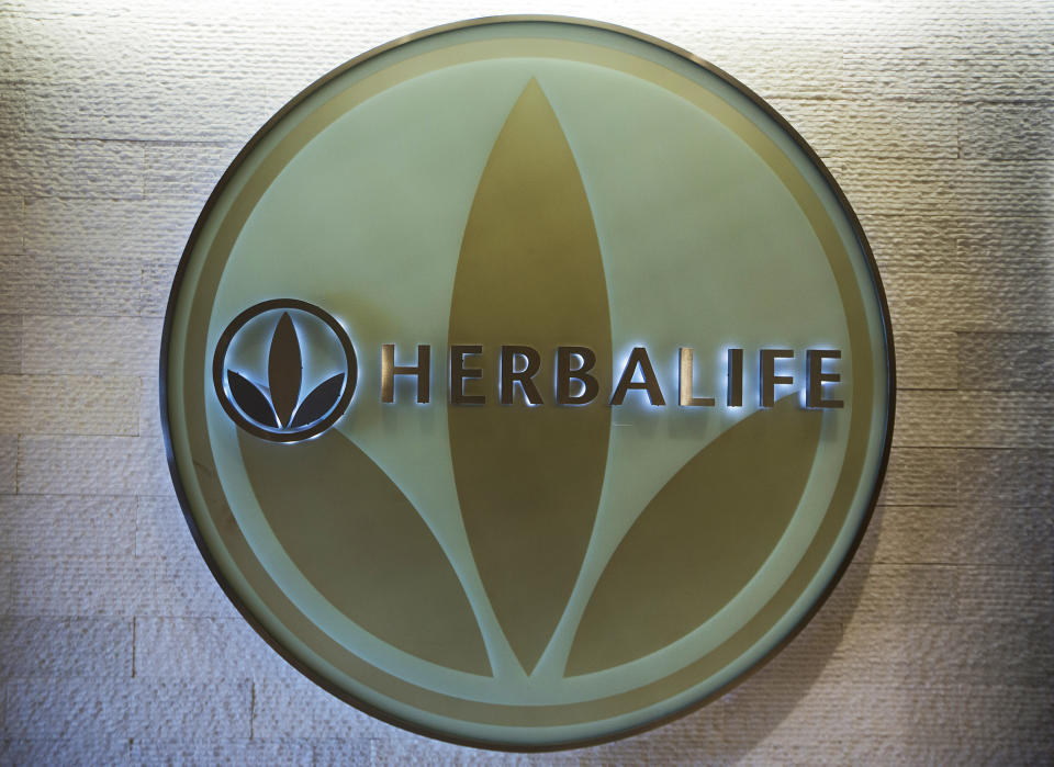 FILE- This May 11, 2016, file photo, shows the Herbalife logo at the company's corporate office, in Los Angeles. Some distributors who claim they were duped by Herbalife’s promises they’d get rich selling health and personal care products are suing the company for as much as $1 billion in damages. (AP Photo/Damian Dovarganes, File)