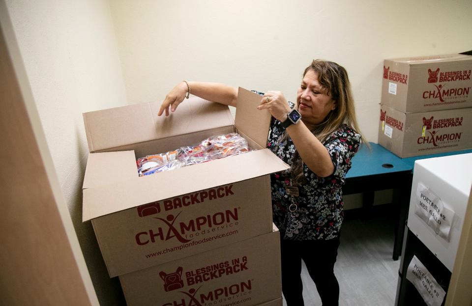 Yasmin Gallo,  the Tice Elementary Program Coordinator for Blessings in a Backpack, shows what is in the boxes of food to be distributed to Tice Elementary School students on Thursday, Feb. 2, 2023, in Fort Myers.