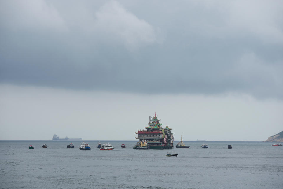 Hong Kong's iconic Jumbo Floating Restaurant is towed away in Hong Kong, Tuesday, June 14, 2022. Hong Kong's iconic restaurant on Tuesday departed the city, after its parent company failed to find a new owner and lacked funds to maintain the establishment amid months of COVID-19 restrictions. (AP Photo/Kin Cheung)