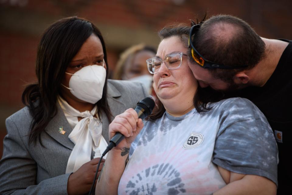 Elizabeth Ricks, center, cries during a demonstration in front of the Fayetteville Police Department on Sunday, Jan. 9, 2022, as she recounts helping Jason Walker. Walker, 37, was shot and killed on Saturday by an off-duty deputy with the Cumberland County Sheriff's Office.