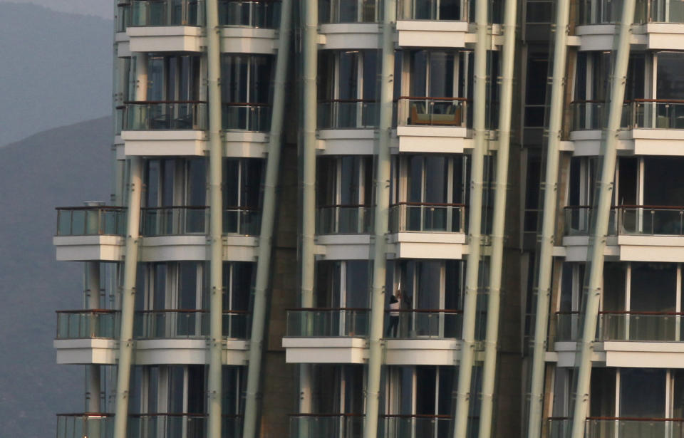 A worker cleans a window at the luxury residential building "Opus Hong Kong," designed by Frank Gehry in Mid-Levels East of Hong Kong Tuesday, Nov. 13, 2012. A Hong Kong property company has sold the luxury apartment in a Frank Gehry-designed building for an eye-popping price of nearly $60 million dollars. Swire Properties said Tuesday it sold the 620 square meter (6,683 square foot) apartment on the ninth floor of its Opus development for 455 million Hong Kong dollars ($58.7 million). It did not say who the buyer was. (AP Photo/Kin Cheung)