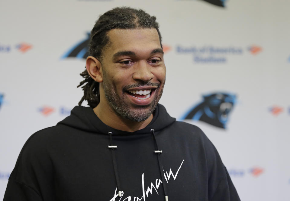 FILE - In this April 5, 2019, file photo, former Carolina Panthers defensive end Julius Peppers answers a question during a news conference in Charlotte, N.C. Josh Heupel, who was the Heisman Trophy runner-up for Oklahoma in 2000, and former North Carolina pass-rushing star Julius Peppers are among 12 players making their first appearance of the College Football Hall of Fame ballot this year. (AP Photo/Chuck Burton, File)