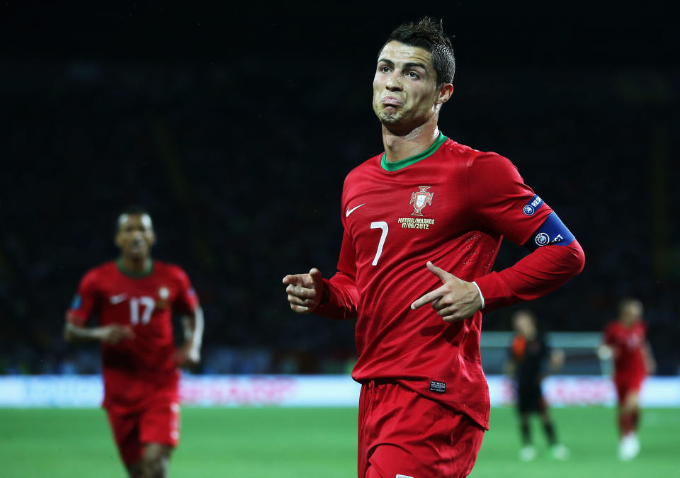 KHARKOV, UKRAINE - JUNE 17: Cristiano Ronaldo of Portugal celebrates scoring his team's first goal during the UEFA EURO 2012 group B match between Portugal and Netherlands at Metalist Stadium on June 17, 2012 in Kharkov, Ukraine. (Photo by Julian Finney/Getty Images)