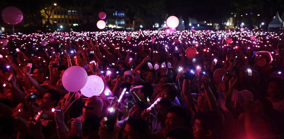 People with LED lights take part in forming a giant pink dot at the Speakers' Corner in Hong Lim Park in Singapore June 30, 2012. About 15,000 people took part in the Pink Dot Sg event to promote acceptance of the Lesbian, Gay, Bisexual, Transgender (LGBT) community in Singapore, the organizer said.  REUTERS/Tim Chong (SINGAPORE - Tags: CIVIL UNREST SOCIETY)