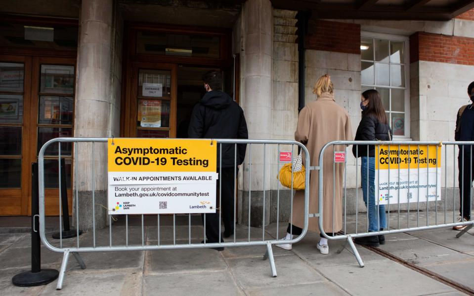People queue to receive Covid tests at Lambeth Town Hall in Brixton on Tuesday - Jamie Lorriman