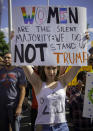 <p>Sofia Hoskins, 17, holds up a sign outside the Albuquerque Convention Center protesting against the appearance of Republican presidential candidate Donald Trump, Tuesday, May 24, 2016, in Albuquerque, N.M. (Joe Lett/The Las Cruces Sun-News via AP) </p>