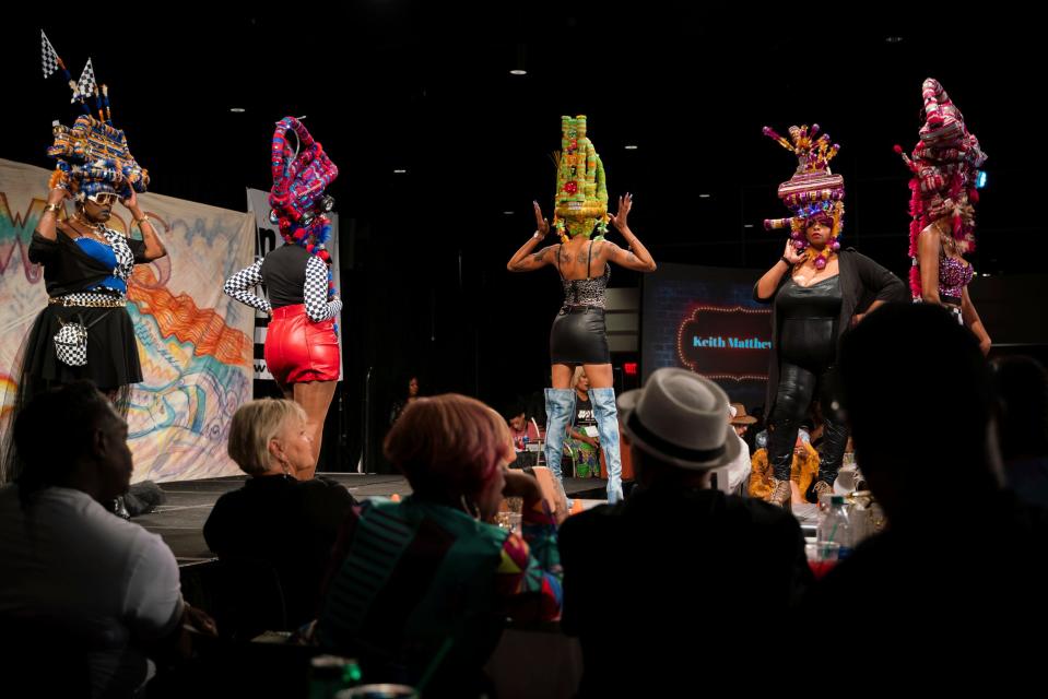 Models wear Keith Matthews' designs while walking in the Hair Wars and Hot Cars runway show at Ford Community and Performing Arts Center in Dearborn on Sunday, Sept. 18, 2022.