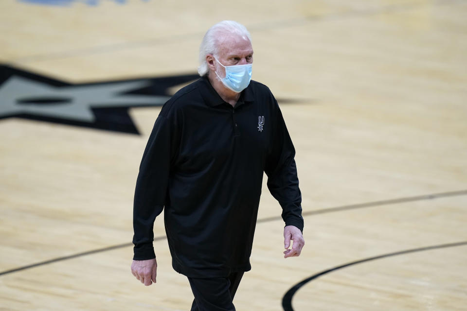 San Antonio Spurs coach Gregg Popovich walks off the court after he was ejected during the first half of the team's NBA basketball game against the Los Angeles Lakers in San Antonio, Wednesday, Dec. 30, 2020. (AP Photo/Eric Gay)