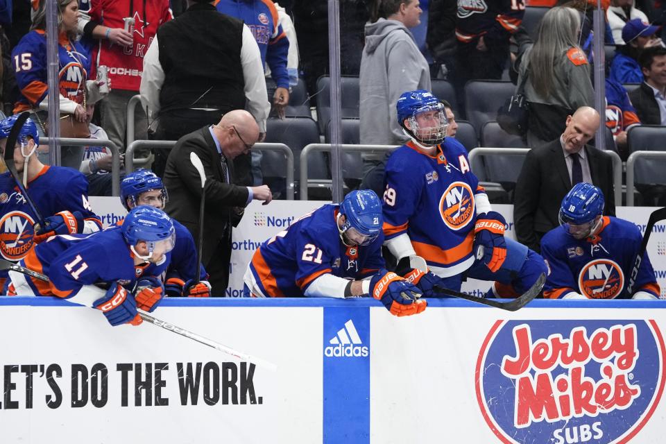 New York Islanders, including Zach Parise (11), Kyle Palmieri (21), and Brock Nelson (29), react to an overtime loss to the Carolina Hurricanes in Game 6 of an NHL hockey Stanley Cup first-round playoff series Friday, April 28, 2023, in Elmont, N.Y. The Hurricanes won 2-1, taking the series. (AP Photo/Frank Franklin II)