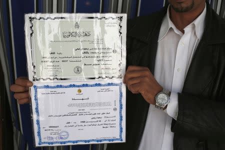 Moncef shows degree certificates of his sister Wahida, who was married to a militant killed in an air strike and is now being held with her son in a prison in Tripoli, during a meeting with Reuters at their house in El Kef, Tunisia June 1, 2016. REUTERS/ Zohra Bensemra