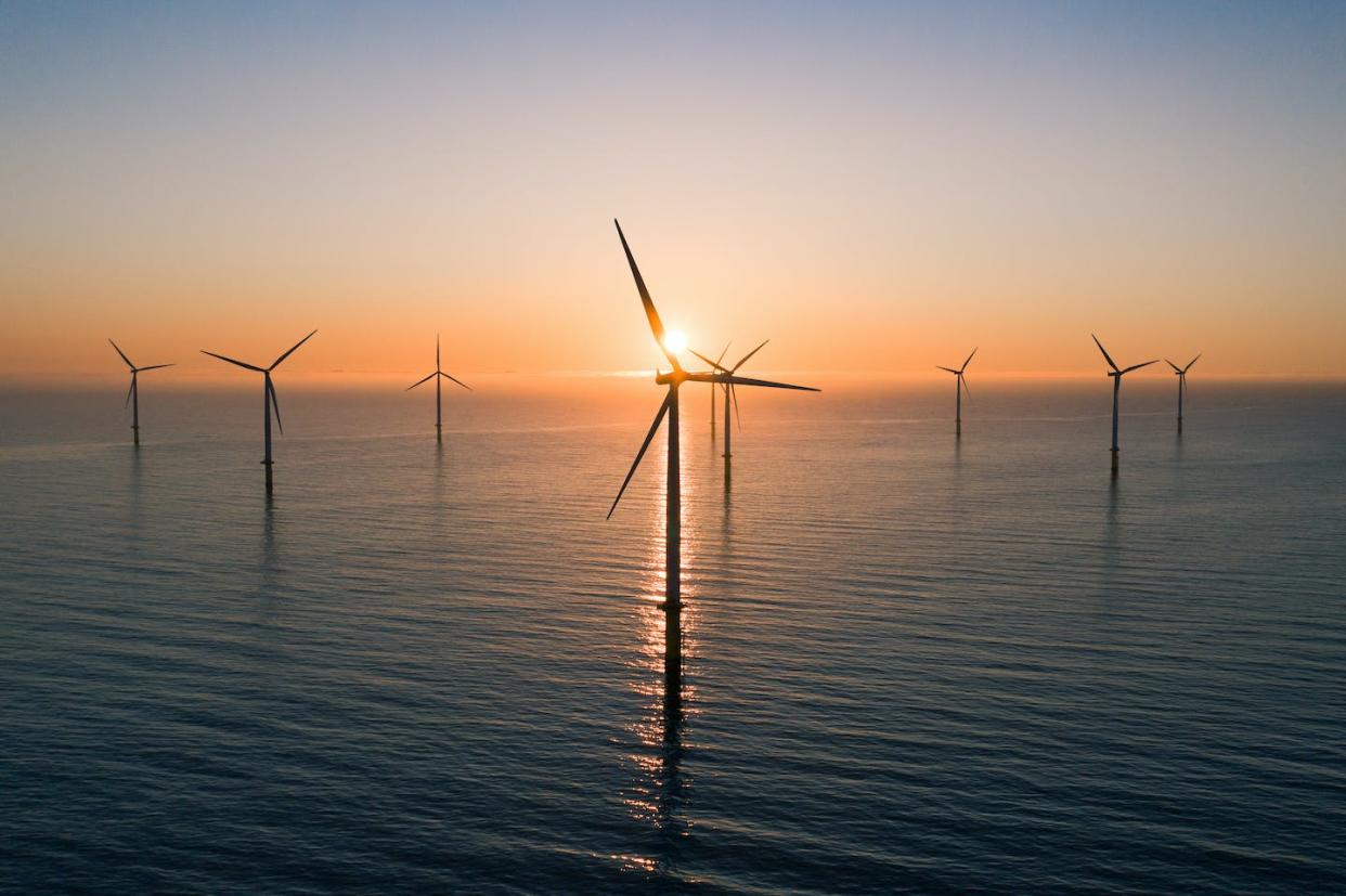 Offshore wind farms will assist in the renewable energy transition and offset the effects of climate change. <a href="https://www.gettyimages.com/detail/photo/offshore-wind-turbines-at-sunrise-seen-from-an-royalty-free-image/1321503681" rel="nofollow noopener" target="_blank" data-ylk="slk:Abstract Aerial Art/DigitalVision via Getty Images;elm:context_link;itc:0;sec:content-canvas" class="link ">Abstract Aerial Art/DigitalVision via Getty Images</a>