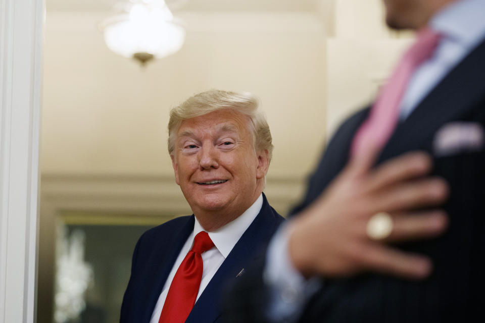 President Donald Trump speaks about attending the World Series as he departs a Presidential Medal of Freedom ceremony for auto racing great Roger Penske in the Oval Office of the White House, Thursday, Oct. 24, 2019, in Washington. (AP Photo/Alex Brandon)