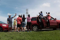 <p>People stop on a highway near a mobile phone antenna tower to check for mobile phone signal, after the area was hit by Hurricane Maria, in Dorado, Puerto Rico, Sept. 22, 2017. (Photo: Alvin Baez/Reuters) </p>