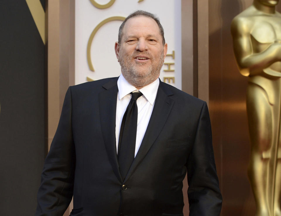 FILE - Movie mogul Harvey Weinstein arrives at the Oscars at the Dolby Theatre in Los Angeles, March 2, 2014. Five years after women's stories about him made the #MeToo movement explode, Weinstein is going on trial in Los Angeles, the city where he once was a colossus at the Oscars. Jury selection for an eight-week trial begins Monday, Oct. 10, 2022. (Photo by Jordan Strauss/Invision/AP, File)