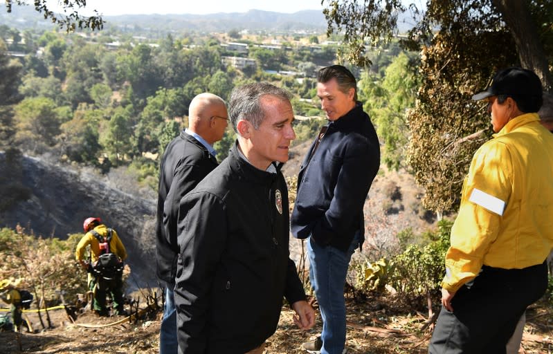 L.A. Mayor Eric Garcetti, L.A. City Councilman Mike Bonin and California Governor Gavin Newsom view a burned home along Tigertail Road in Brentwood